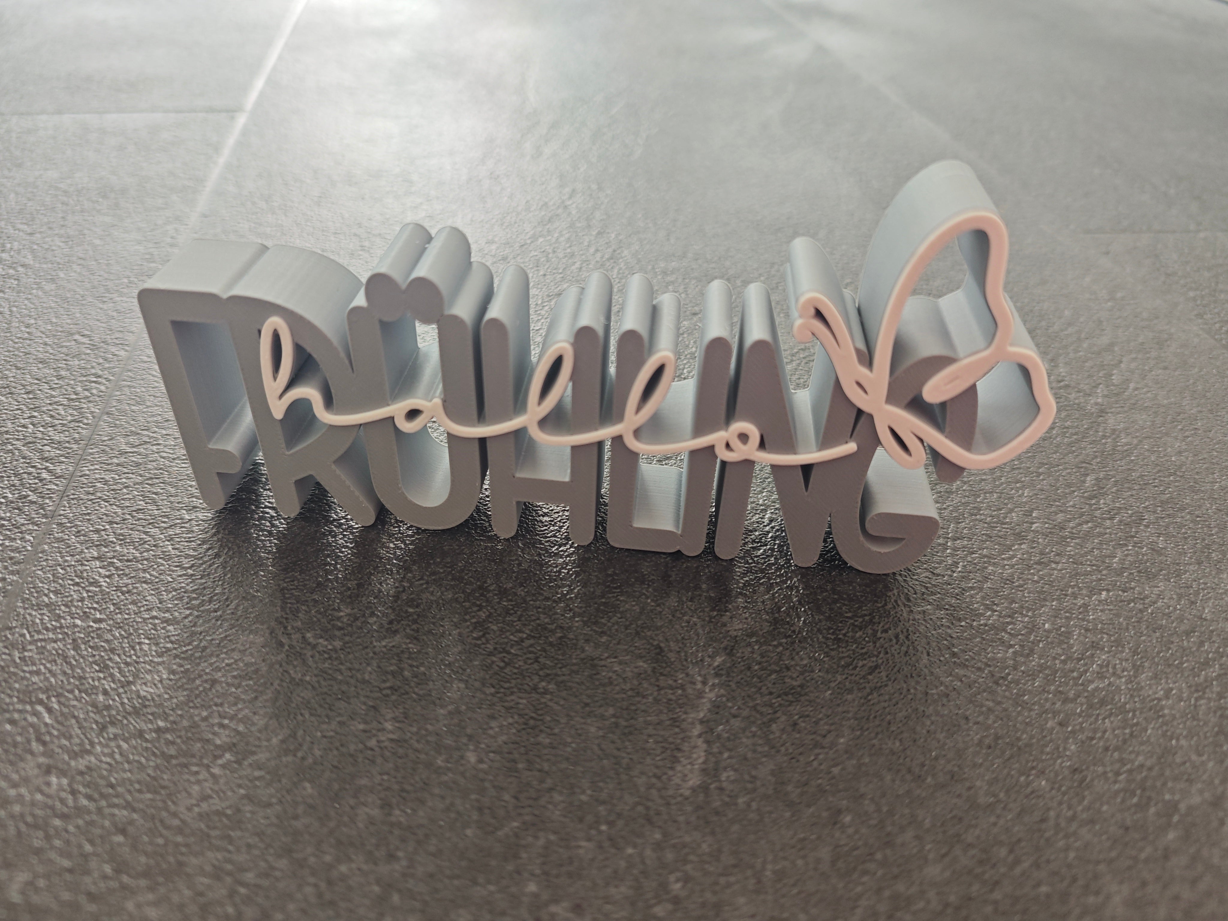 Schrift Hallo Frühling grau, weiss
